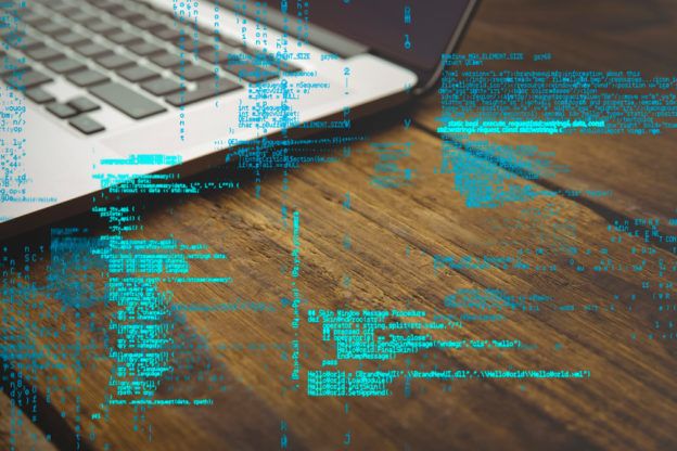 digital composite of laptop with hacking graphic
