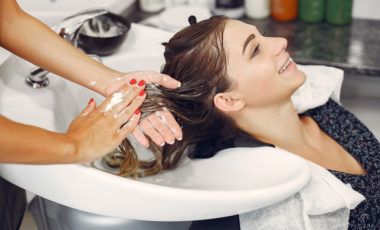 Woman washing head in a hairsalon